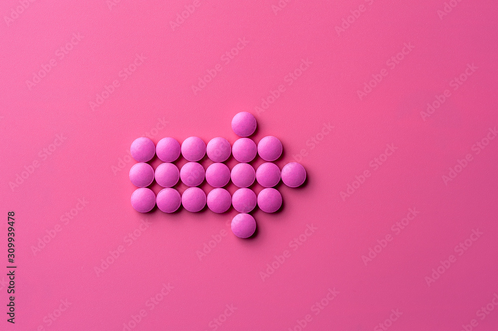 Close-up of pink pills lie on a pink surface Close-up of pink pills lie on a pink surface