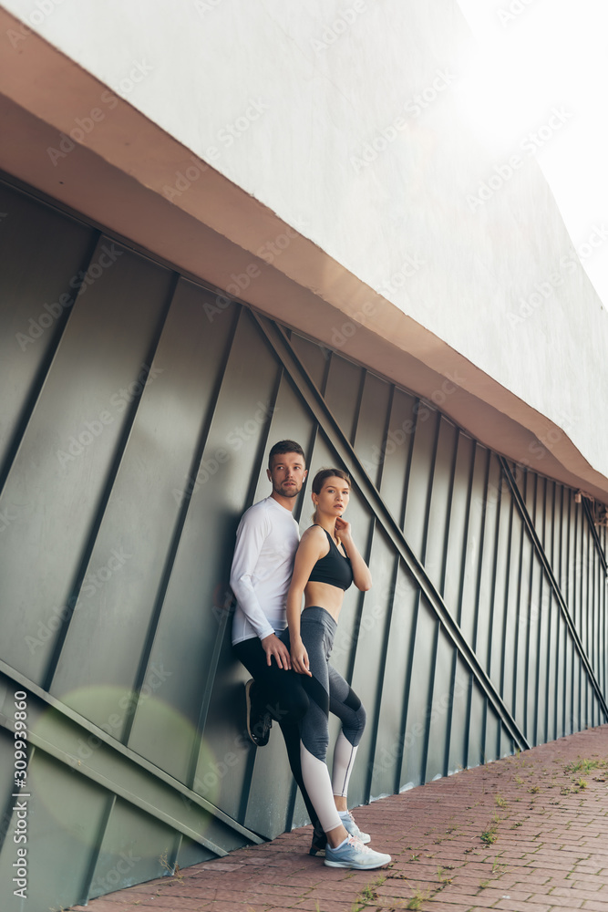 Fitness couple standing outdoors. Sport, workout, healthy lifestyle concept.