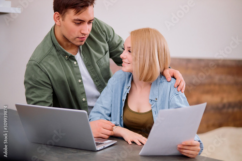 young caucasian man attentively listen and speak with woman, discuss together plans for future, at home