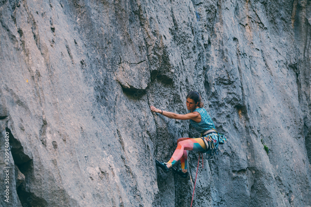 A girl climbs a rock. A girl climbs a rock.