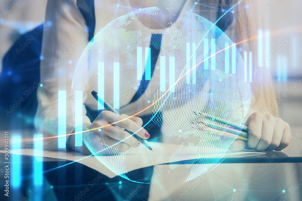 Double exposure of hands making notes with forex chart huds. Stock market concept.