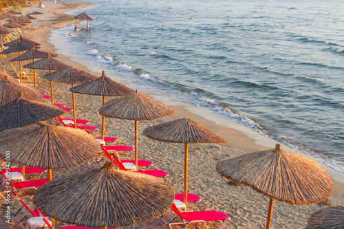 Fototapeta Naklejka Na Ścianę i Meble -  empty beach with umbrellas and empty sunbeds