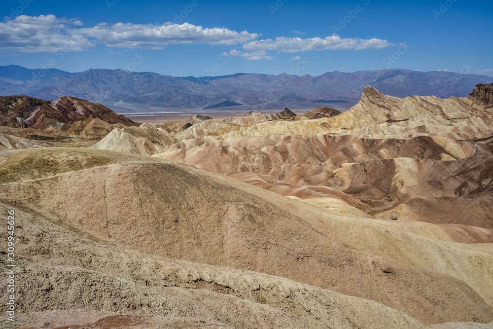 Zabriskie Point, surrounded by a maze of wildly eroded and vibrantly colored badlands in Death Valley, USA