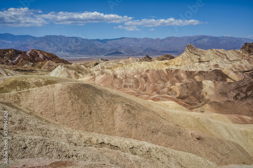 Zabriskie Point, surrounded by a maze of wildly eroded and vibrantly colored badlands in Death Valley, USA