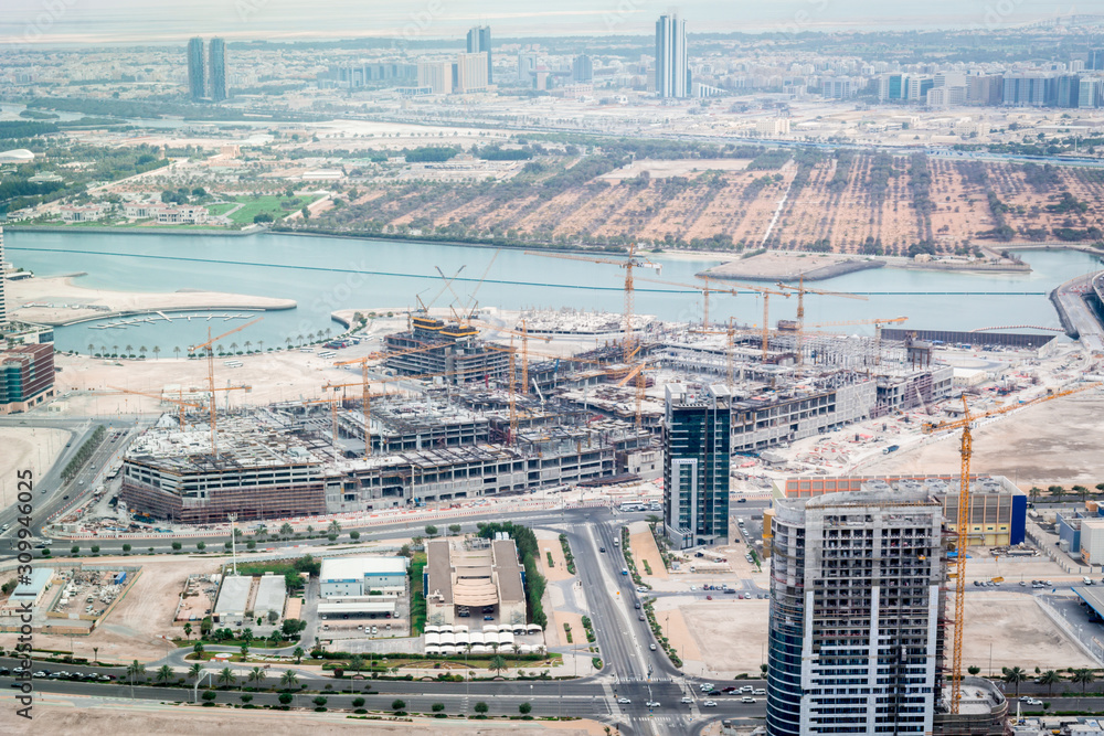 Aerial shot of a Construction site, tools, crane - a new mall under construction - Al Reem Mall