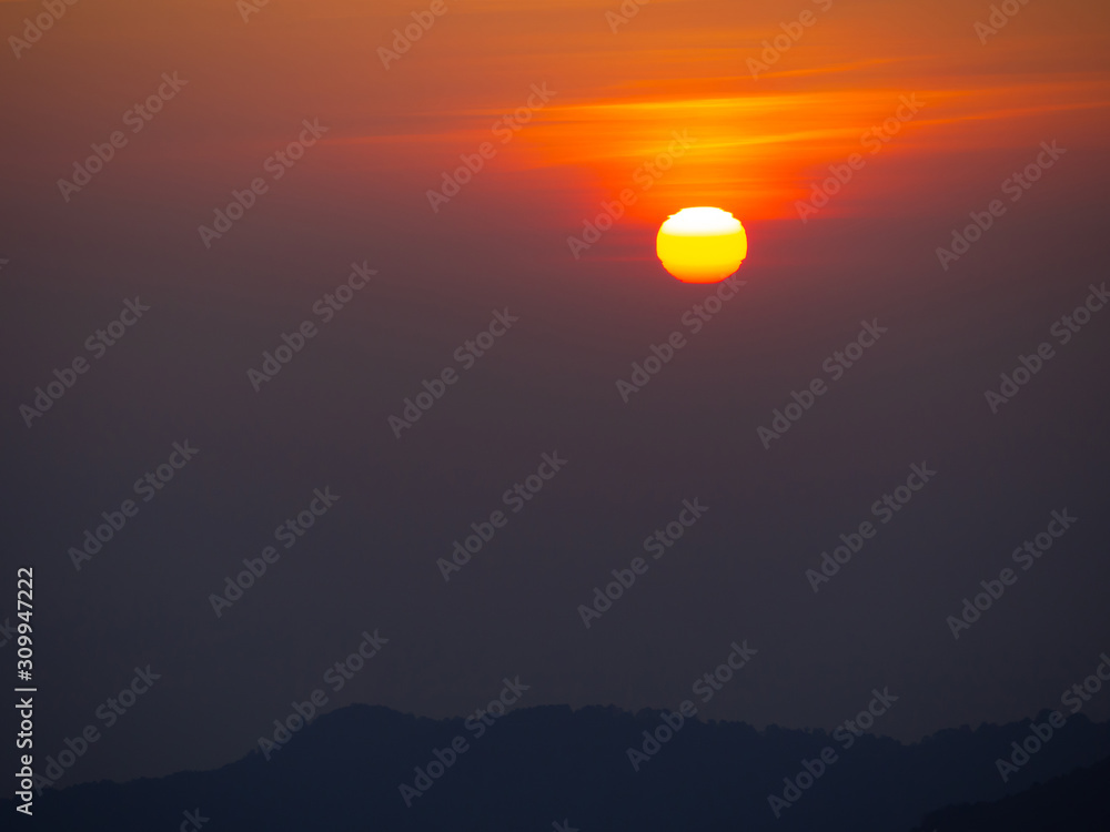 dramatic sunset over cloudy sky.