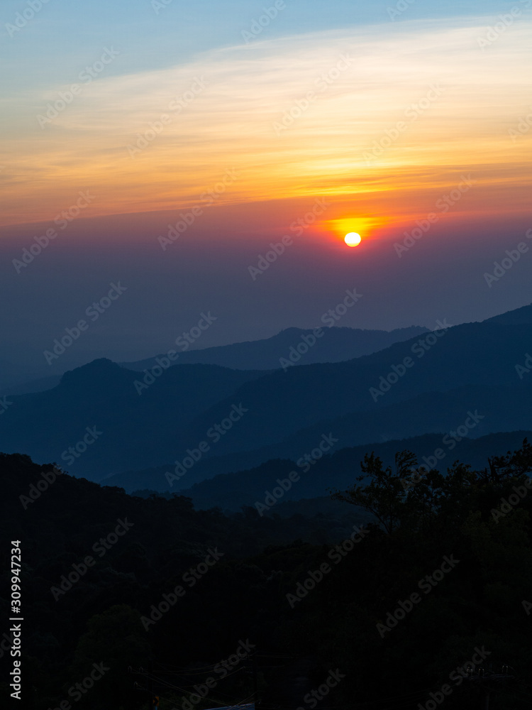 dramatic sunset over cloudy sky.