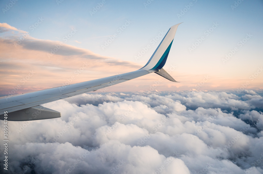 Obraz premium View of wing airplane on cloudy in the sky