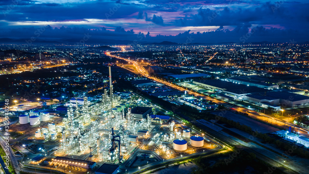 Fototapeta premium refinery zone at night and lighting cityscape with blue sky background