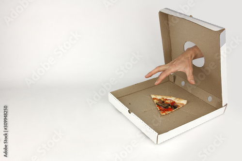 human hand through hole in fastfood box try to takes last piece of pizza, white background, concept of greed