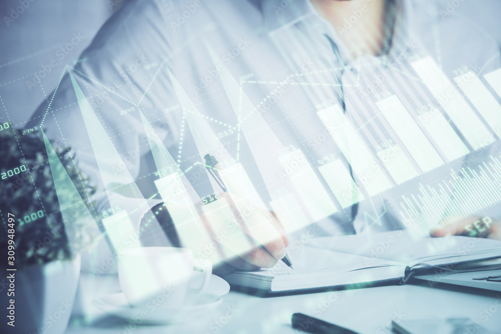 Double exposure of man's hands writing notes of stock market with forex chart. Double exposure of man's hands writing notes of stock market with forex chart.