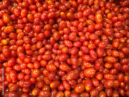 Fresh red cherry tomatoes in supermarket.Fresh cherry tomatoes background texture. © Pichchapatr