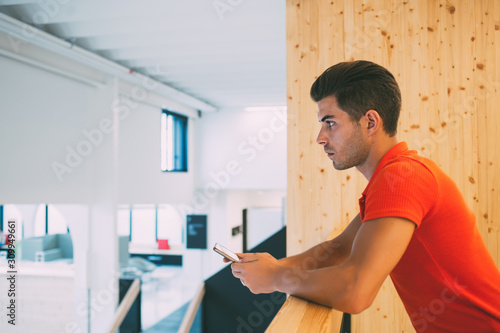 Concentrated freelancer messaging with coworker on phone