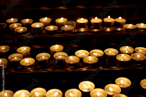 Burning candles in a church close-up 