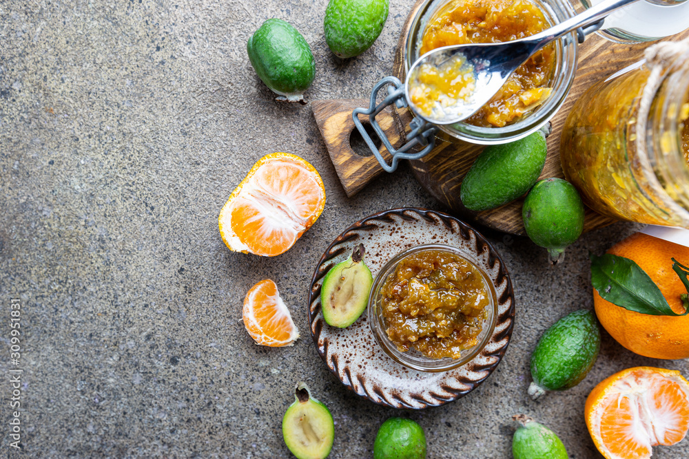 Tropical fruit preserves, homemade feijoa and tangerine jam with fresh fruits, top view Tropical fruit preserves, homemade feijoa and tangerine jam with fresh fruits, top view