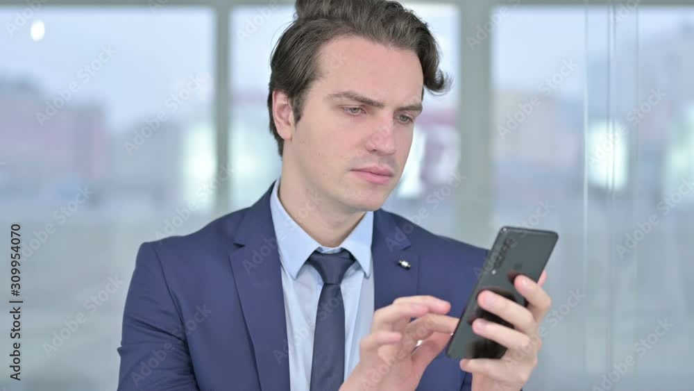 Portrait of Relaxed Young Businessman using Smartphone Portrait of Relaxed Young Businessman using Smartphone