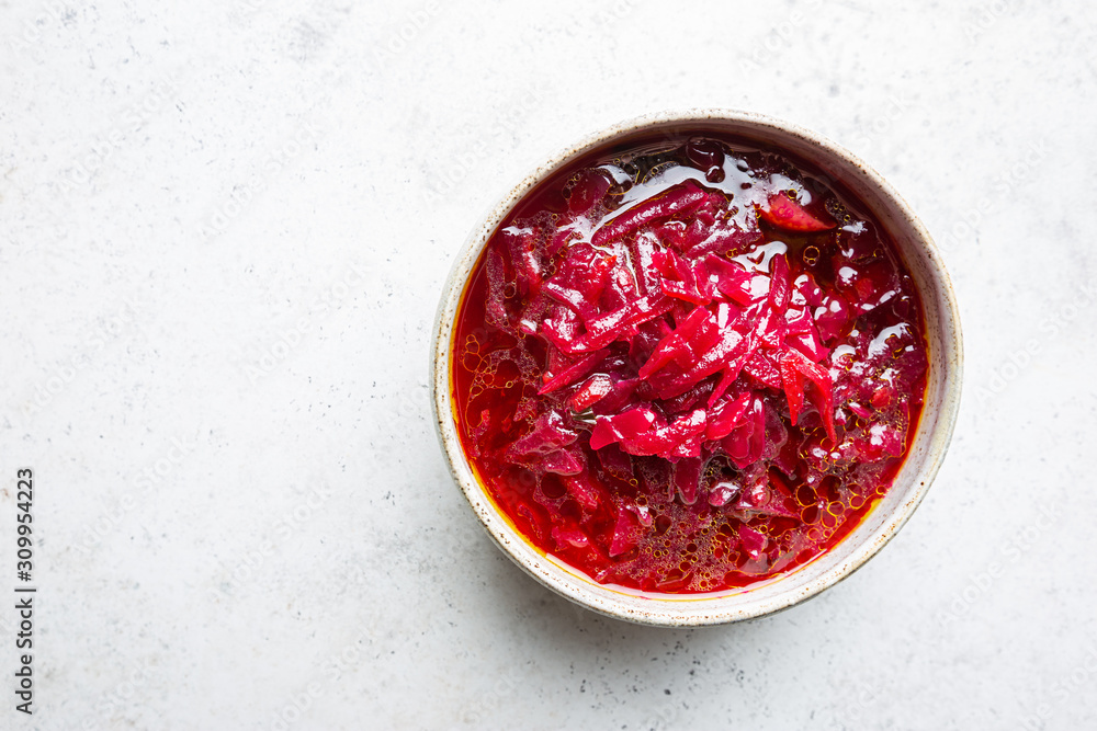 Traditional Ukrainian Russian vegetable beet soup, borscht on white background, top view