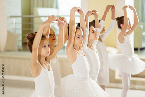 Fotografie, Obraz sweet caucasian little ballerinas wearing white tutu perdorming dance together,