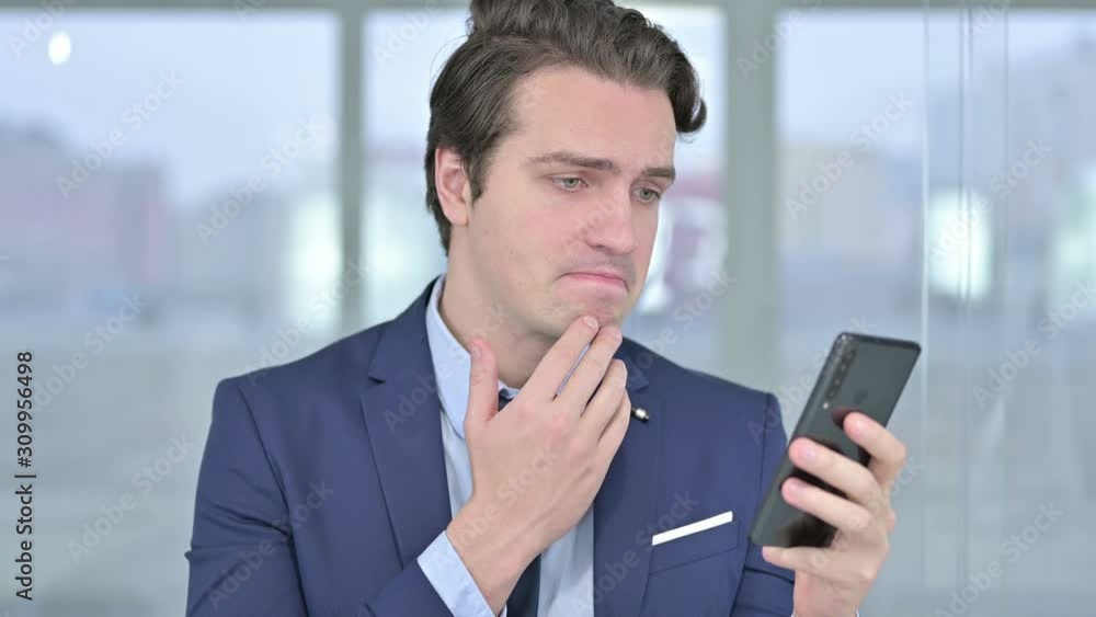 Portrait of Young Businessman reacting to Failure on Smartphone Portrait of Young Businessman reacting to Failure on Smartphone