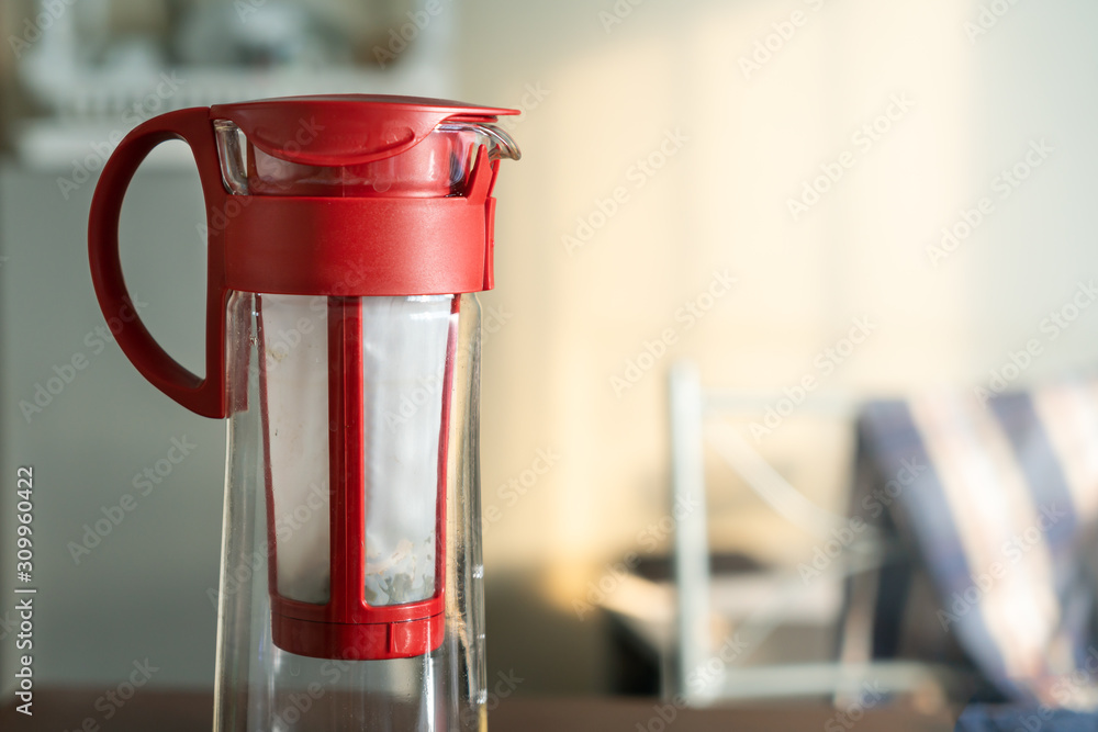 A empty red tea jug on the table