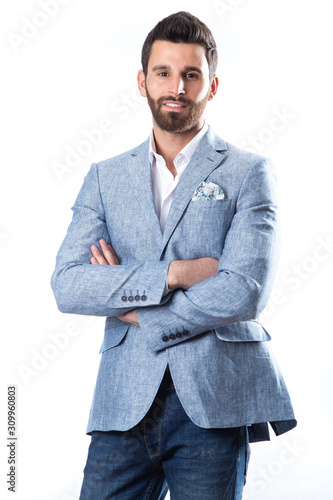A young man wearing a Blazer in blue jeans on a white background