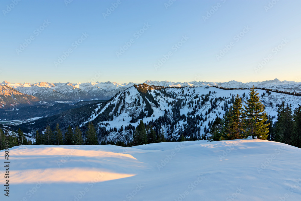 Sunset with snowy mountains in winter. Allgau Alps, Bavaria, Germany