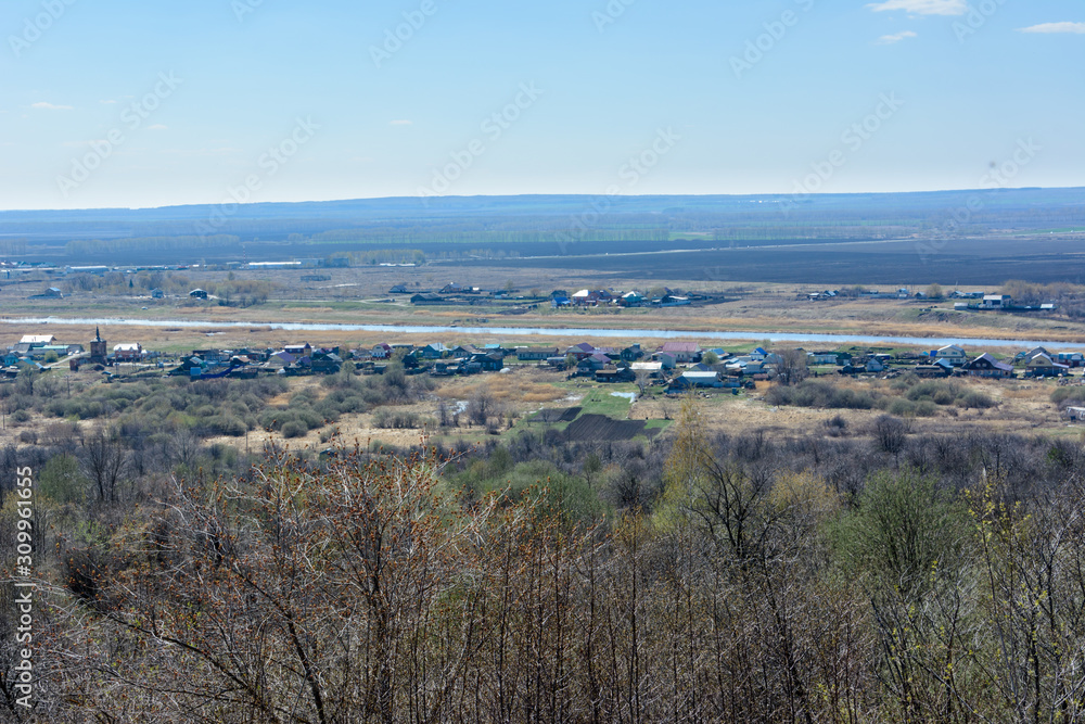 Beautiful view of the fields, meadows, the village and the river Sviyaga. Panorama of the famous Sviyaga river from a high mountain. Ulyanovsk region, Russia.