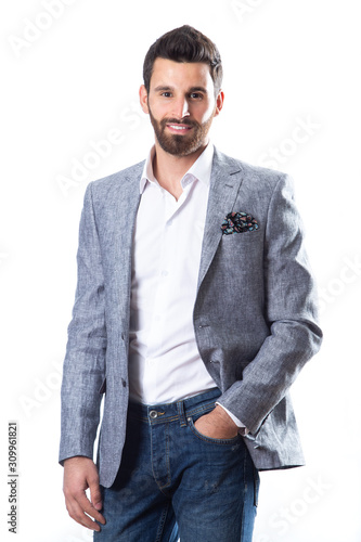 A young man wearing a Blazer in blue jeans on a white background