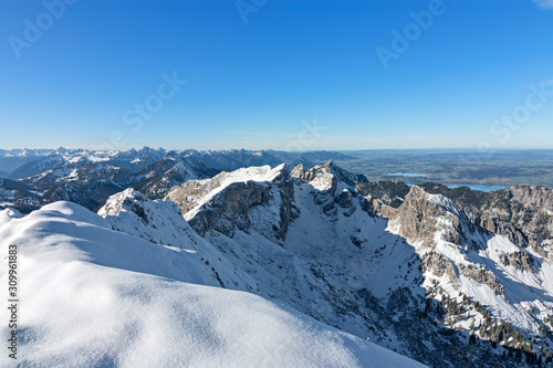 Snow-covered rocky mountains above the lowland in the Allgau area at a beautiful day in autumn. Bavaria  Germany. Copy space