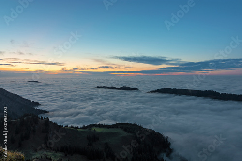 Hills above a sea of clouds at sunset. Bavaria  Germany