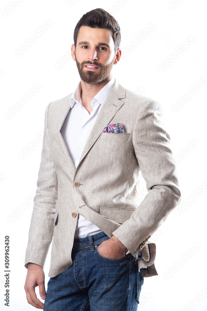 A young man wearing a Blazer in blue jeans on a white background A young man wearing a Blazer in blue jeans on a white background