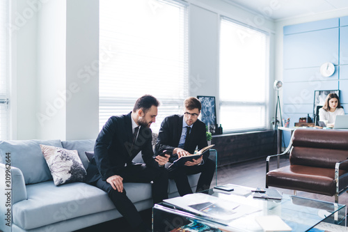 Business people spending time on sofa at office