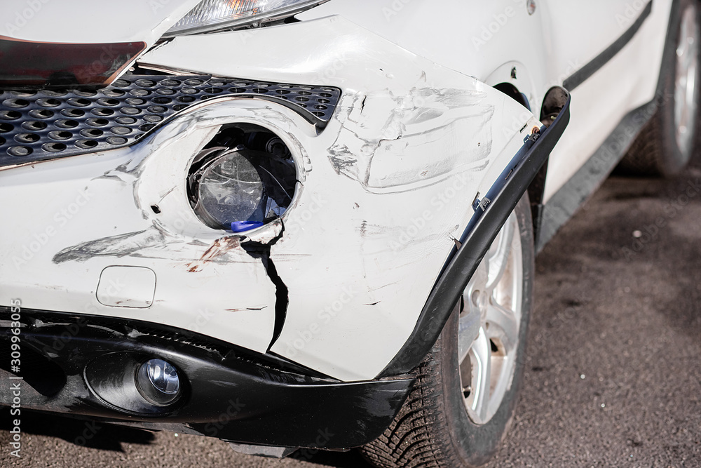 Broken Car after a Crash. Damaged Wing and Headlamp of a Car