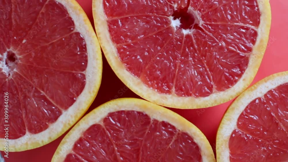halves of red grapefruit on red background halves of red grapefruit on red background
