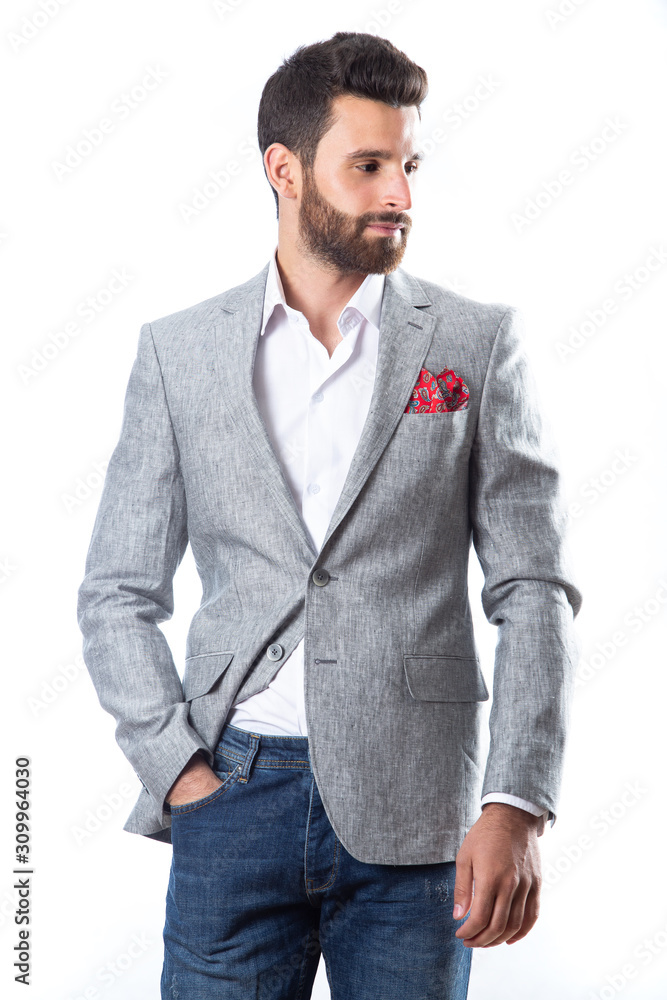 A young man wearing a Blazer in blue jeans on a white background A young man wearing a Blazer in blue jeans on a white background