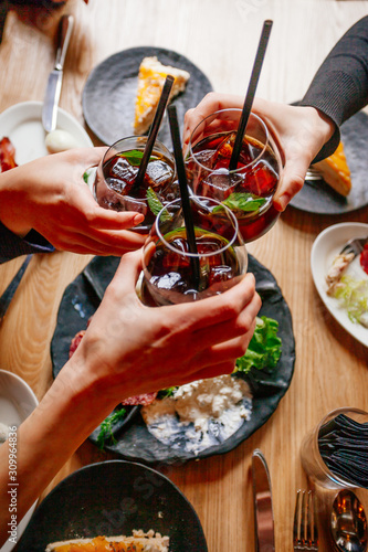 Young ladys enjoying time together in cafe, friends drinking cold drinks and eat breakfasts together.