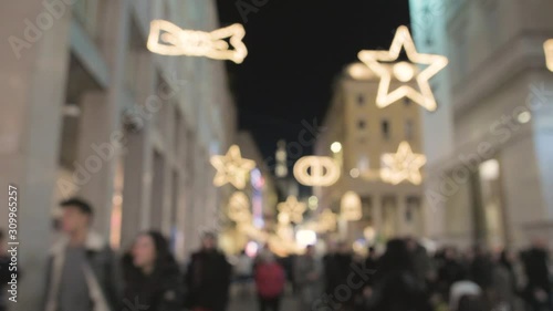 Blurred crowd of people and tourist shop for christmas gifts under christmas lights