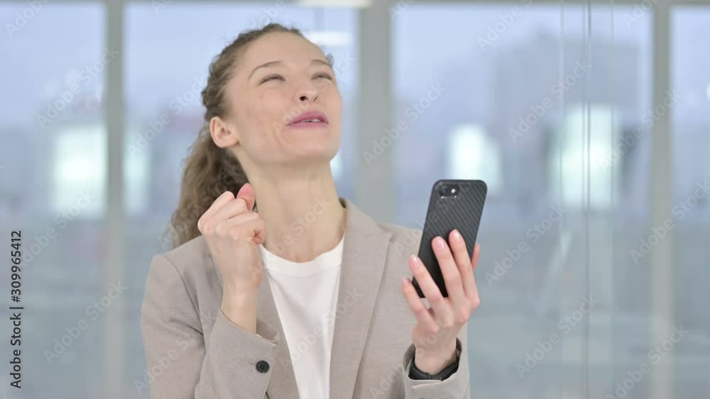 Portrait of Young Businesswoman Celebrating Success on Smartphone Portrait of Young Businesswoman Celebrating Success on Smartphone