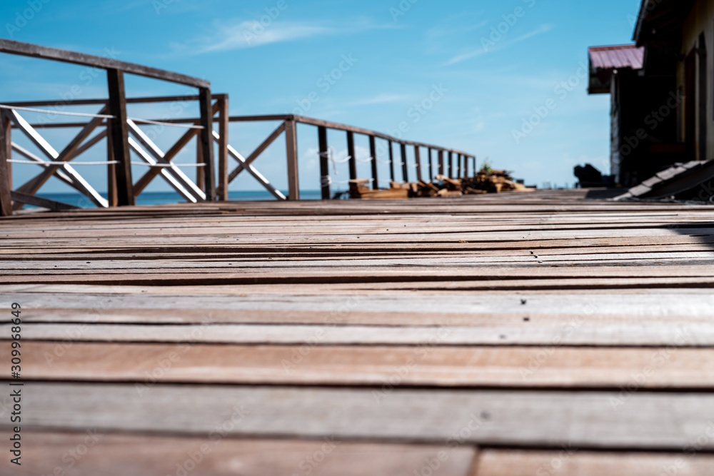 Naklejka premium Wooden pier by the beach in tropical country.