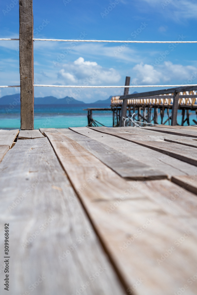 Wooden pier by the beach in tropical country.