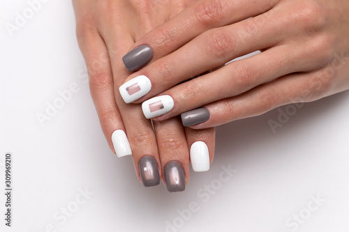 White-gray manicure with squares. New Year s gray manicure. Square nails. Nails closeup.