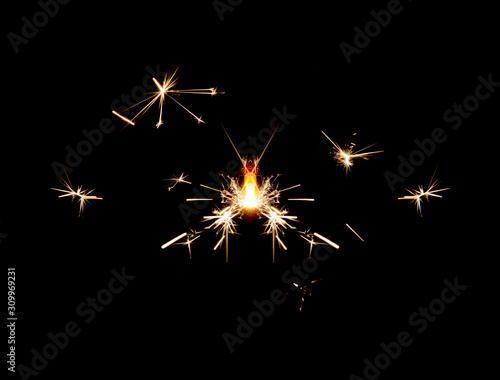 Burning sparkler isolated on black background