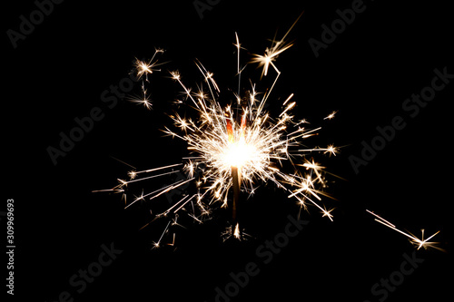 Burning sparkler isolated on black background