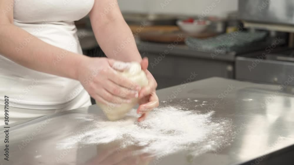Professional chef kneading the dough. Preparing the ingredients. Healthy food concept Stock