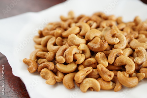 cashew nuts in a dish with wood table..
