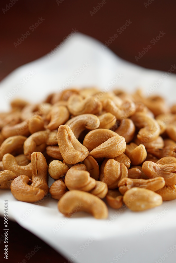Close-up of cashew nuts in a dish with wood table. Close-up of cashew nuts in a dish with wood table.