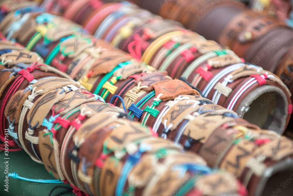 Stylish leather bracelets with natural stones on display at the fair of artisans.