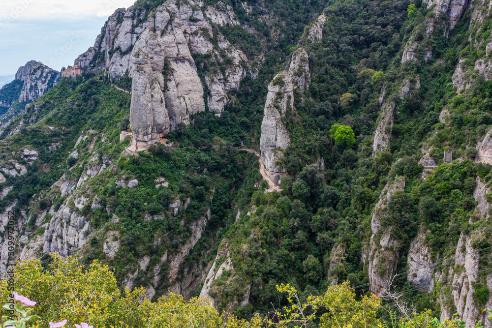View of the path that runs along the side of the cliffs to the Hermitage of St. Cova in the background, Monistrol de Monserrat, Catalonia, Spain