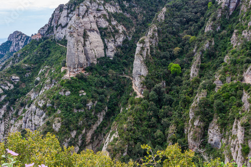 View of the path that runs along the side of the cliffs to the Hermitage of St. Cova in the background, Monistrol de Monserrat, Catalonia, Spain