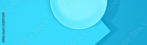 top view of empty plate on colorful blue surface, panoramic shot